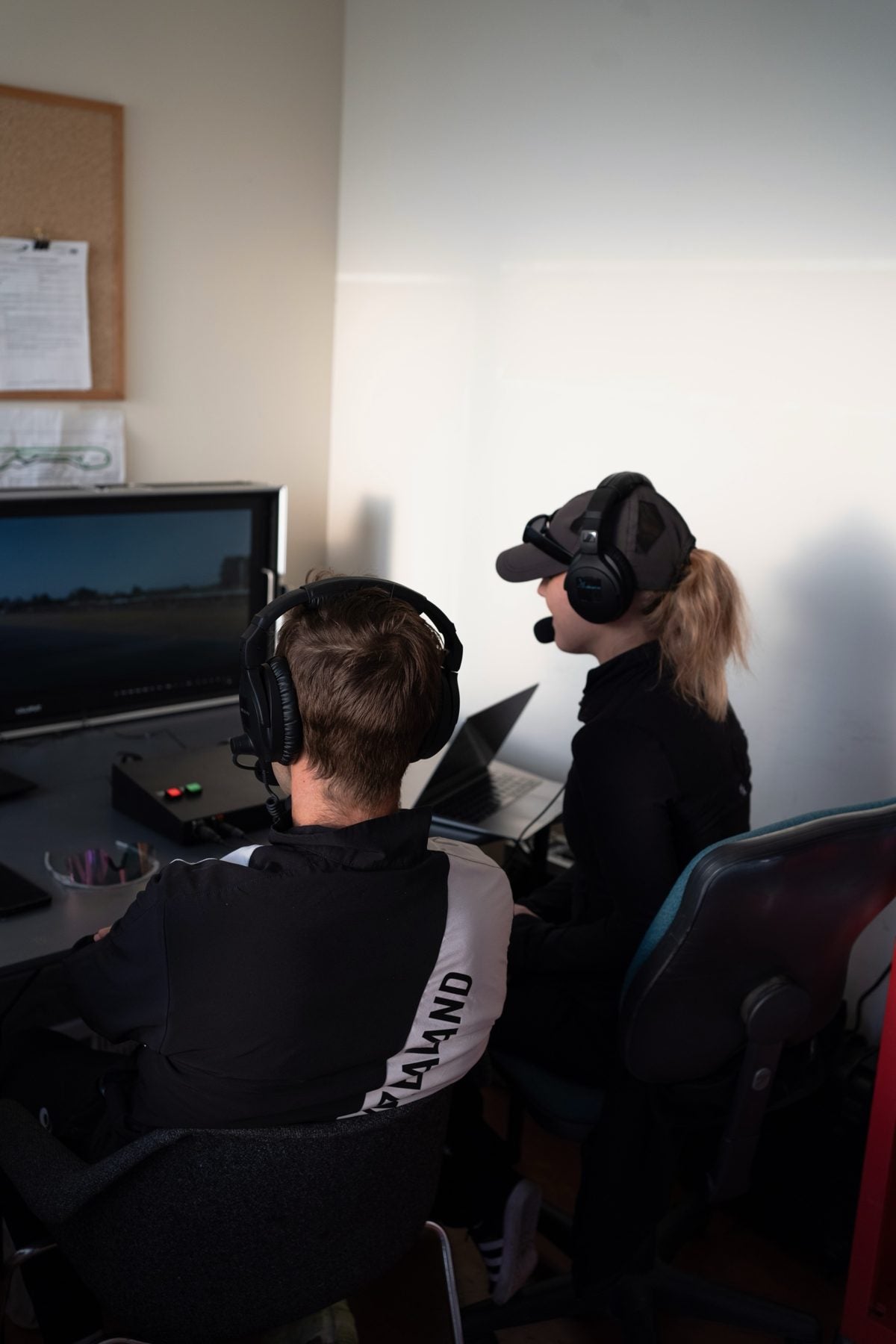 The two of us in the commentary booth wearing headsets