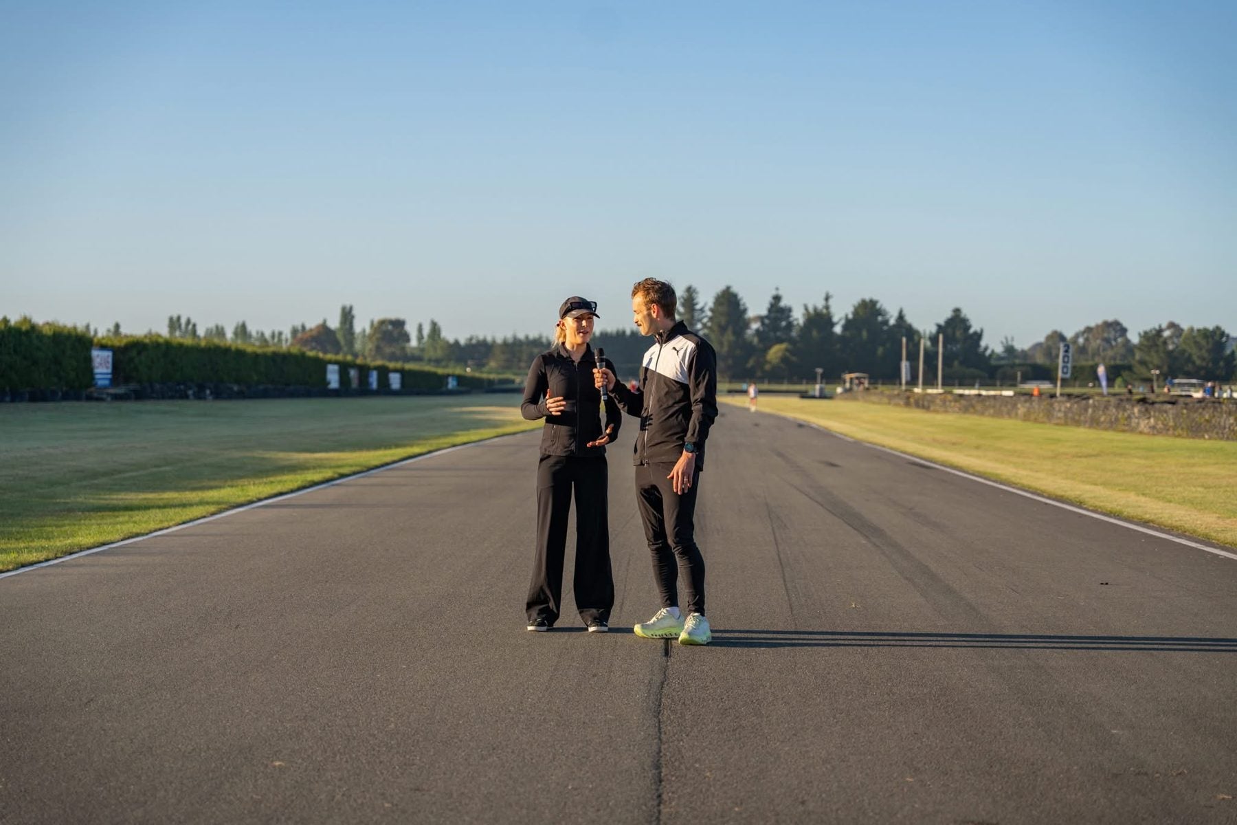 Maya and Oska at a track with the mic
